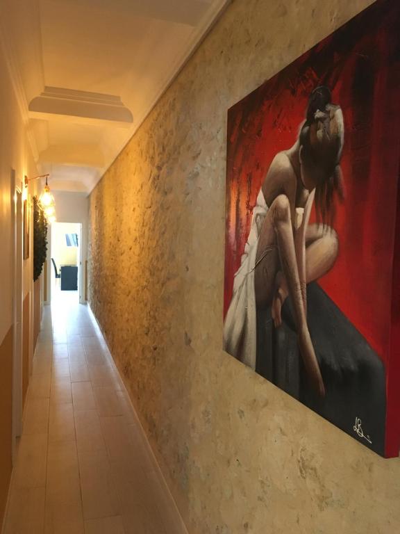 a painting of a woman on a wall in a hallway at Apartment San Carlos Alicante in Alicante