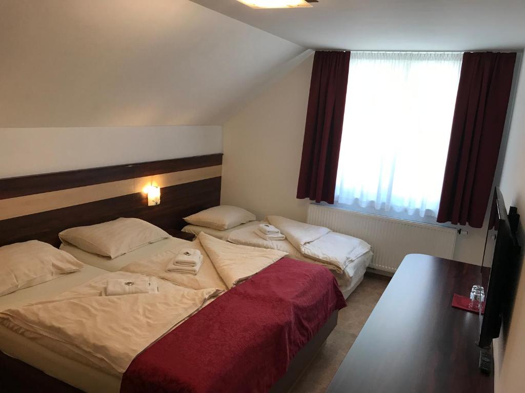 Postel nebo postele na pokoji v ubytování Guest House Hober