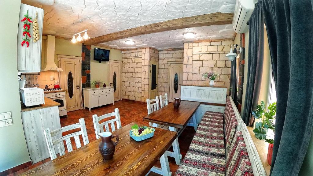 a kitchen and dining room with a wooden table and chairs at Retro Hostel & Tours in Yerevan