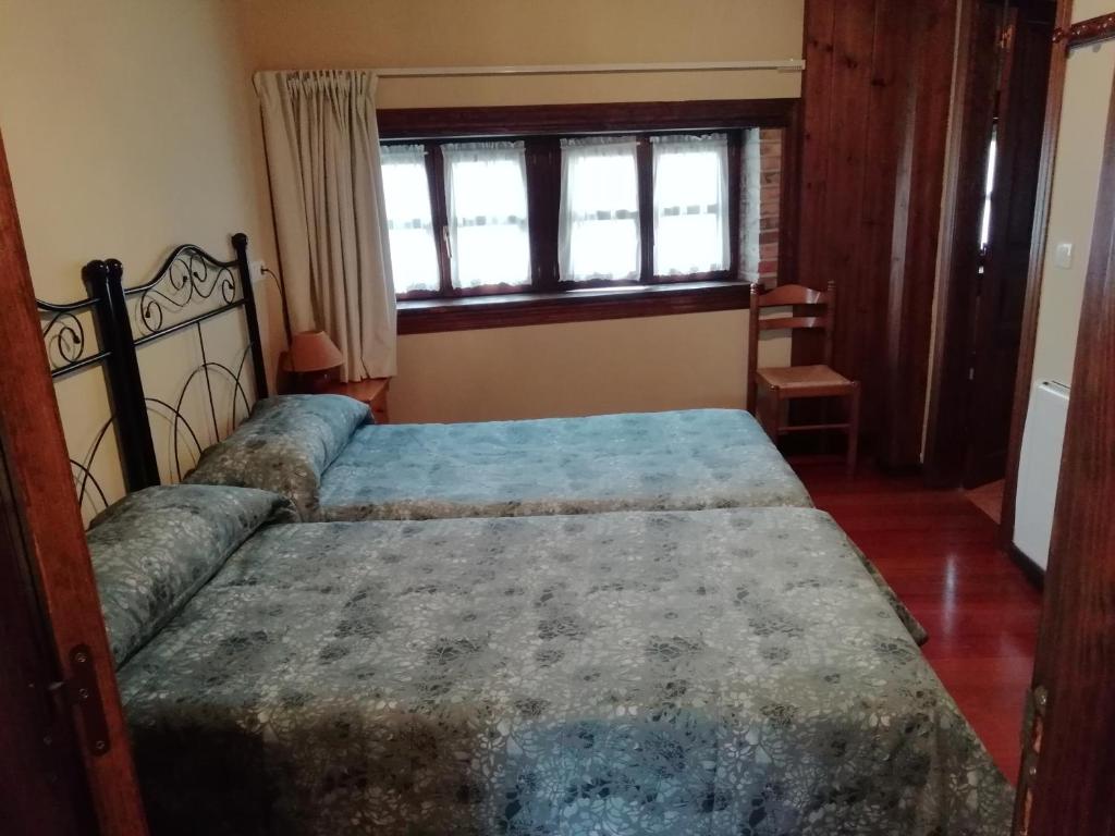 a bedroom with a large bed in a room at Apartamentos Begoña in Llanes