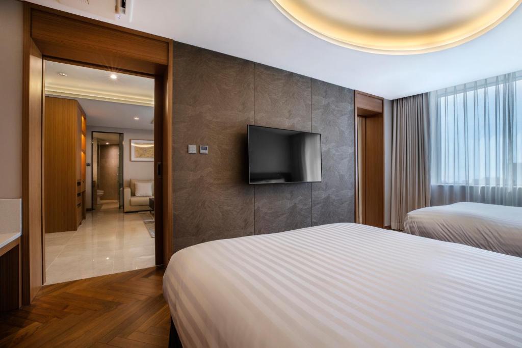 Postel nebo postele na pokoji v ubytování Shin Shin Hotel Jeju Airport
