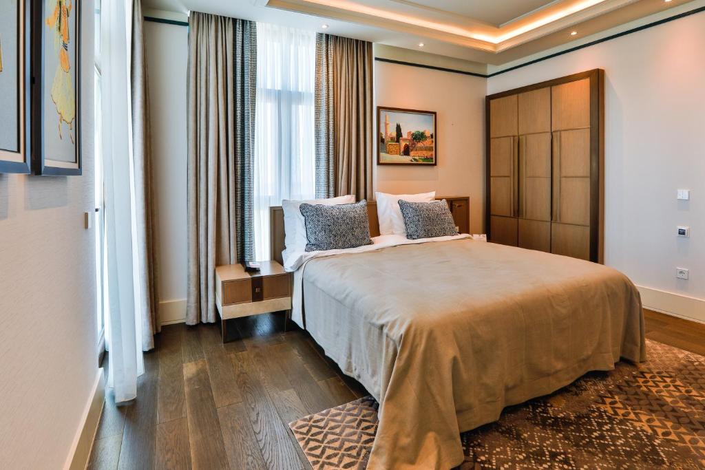 a hotel room with a bed and a large window at Dreamland Golf Hotel Baku in Baku