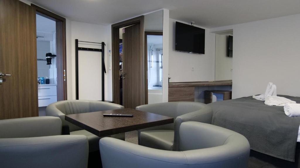 a room with a bed and a table and chairs at Botel Gracia in Bratislava