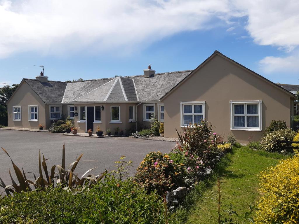 a house with a driveway in front of it at Killilagh House Accommodation in Doolin