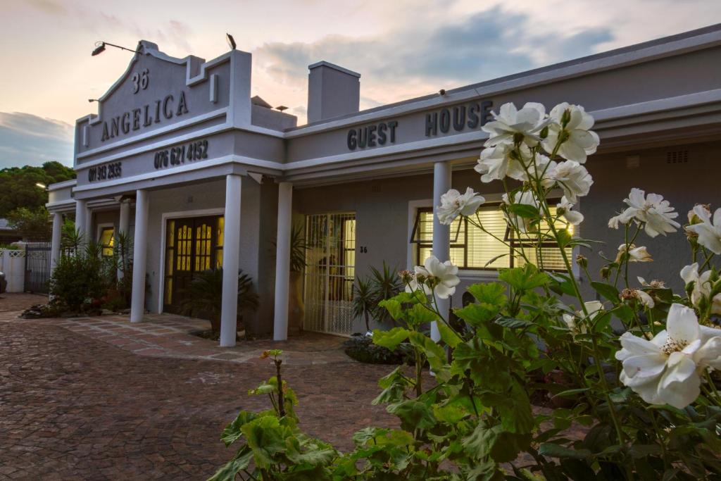 a building with white flowers in front of it at Angelica Guest House in Boksburg