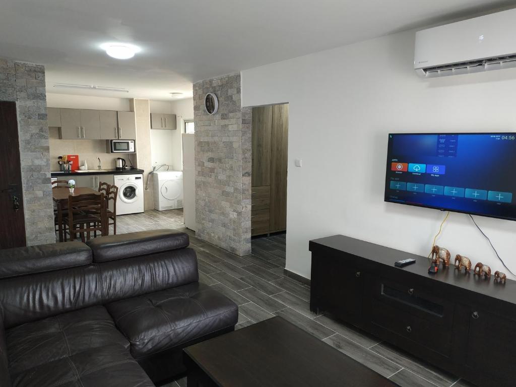 a living room with a couch and a flat screen tv at lake view in Tiberias