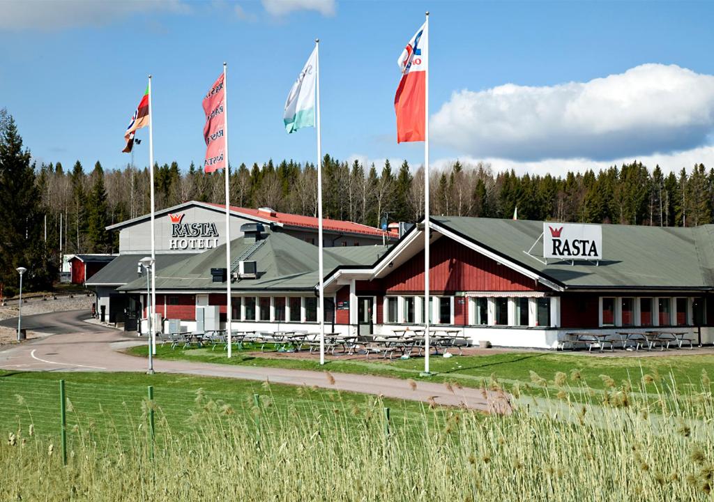 a building with several flags in front of it at Rasta Grums in Grums