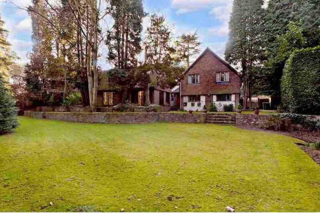 a house with a large yard in front of it at Private Guest House with full kitchen living room and utility room Completely Separate from the Main House in Cobham