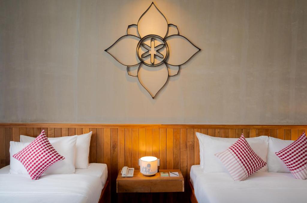 Postel nebo postele na pokoji v ubytování Phka Chan Hotel
