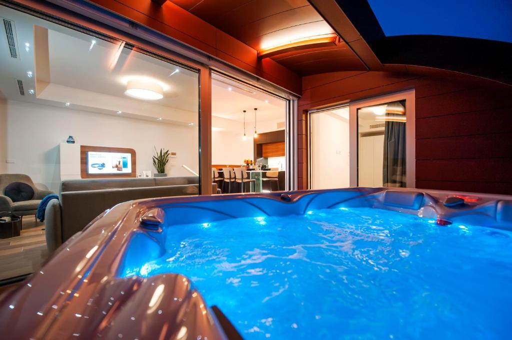 a large blue hot tub in a living room at The Q - Superior Apartment in Rovinj