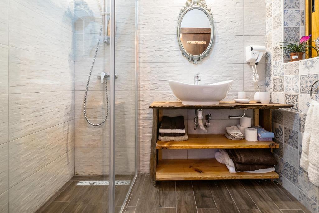 a bathroom with a sink and a shower at Kharmen A 1565s House with Seaviews in Birgu