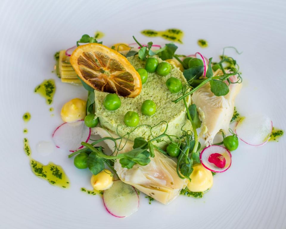 a plate of food with fish and vegetables on it at The Randolph Hotel in Southwold