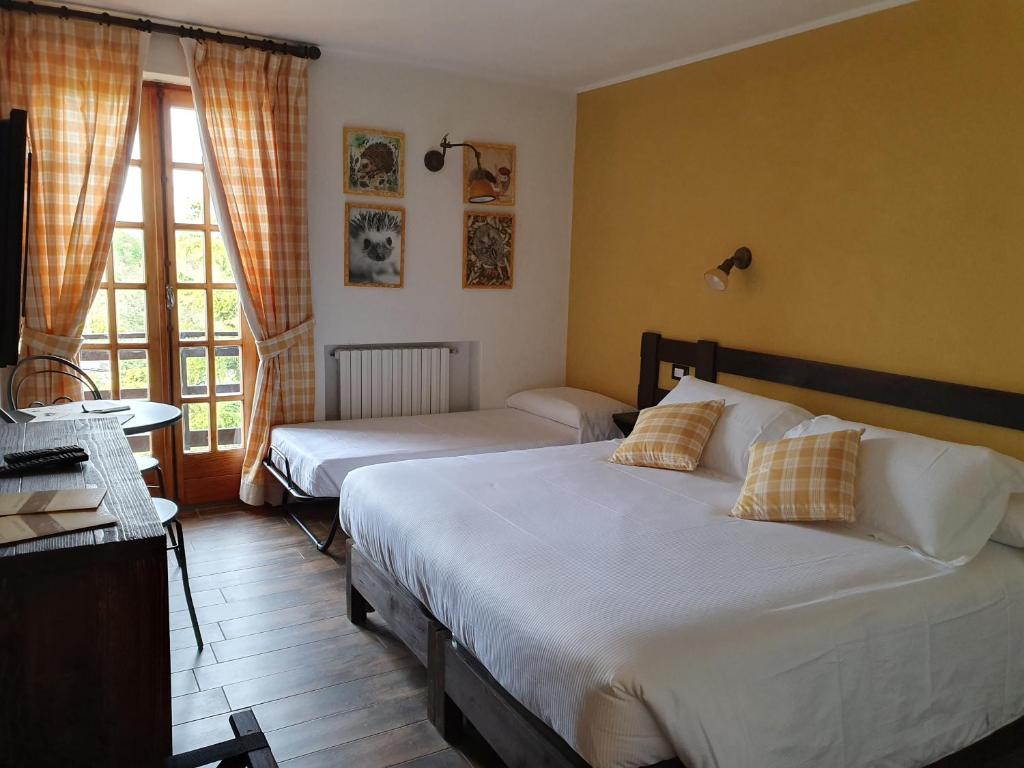 Postel nebo postele na pokoji v ubytování Locanda Il Rustichello