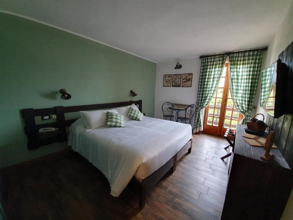 Postel nebo postele na pokoji v ubytování Locanda Il Rustichello