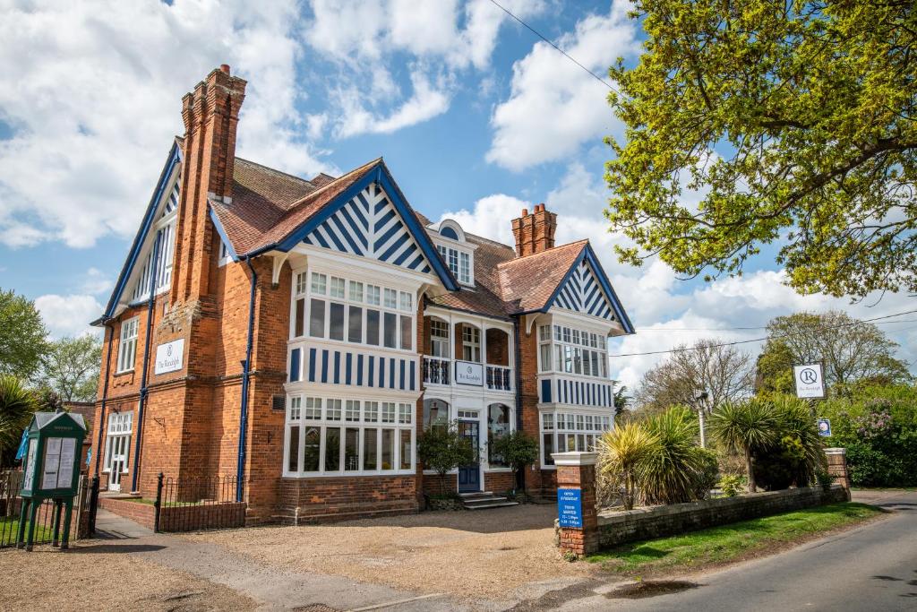 a large brick building with white windows at The Randolph Hotel in Southwold