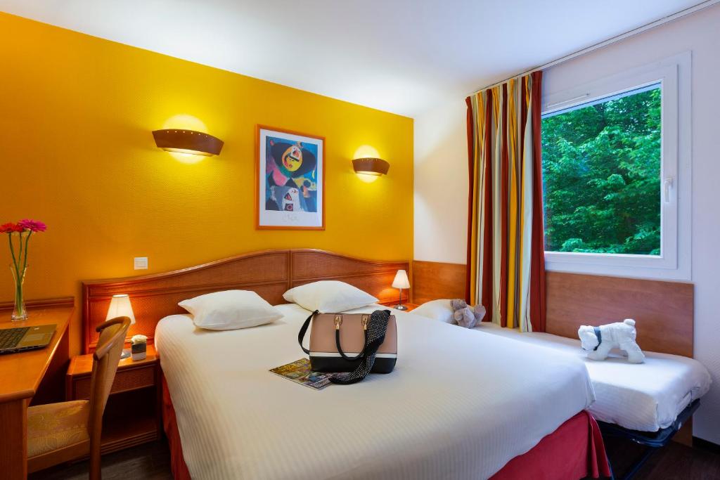 
Un ou plusieurs lits dans un hébergement de l'établissement Hotel Roi Soleil - Amnéville
