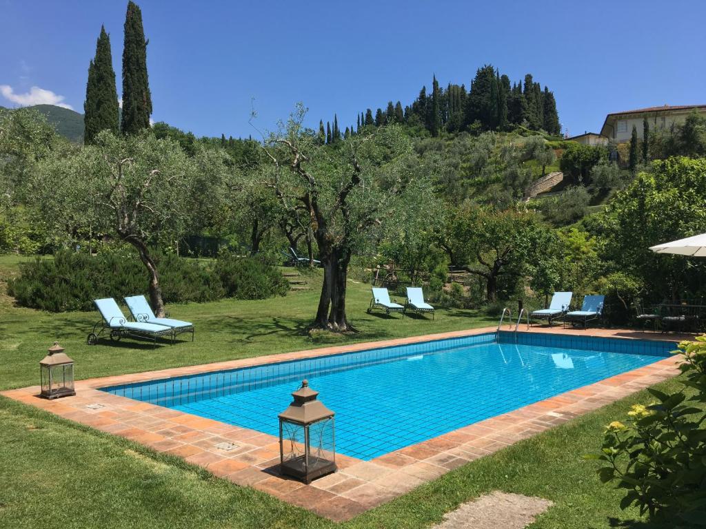 a swimming pool in the yard of a house at Il Chiostrino in Gardone Riviera