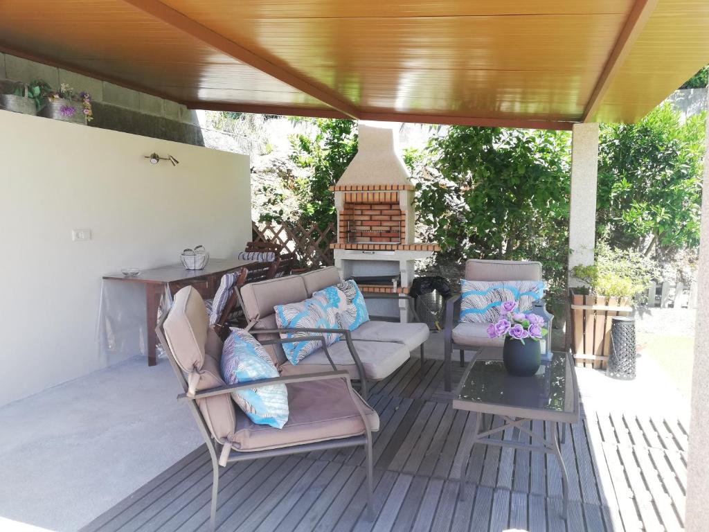 a patio with two chairs and a table at Twin House - Amarante in Amarante