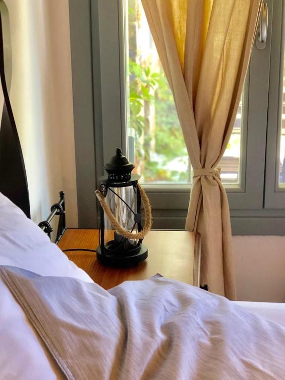 a bedroom with a bed and a window at Nefeli in Livadi