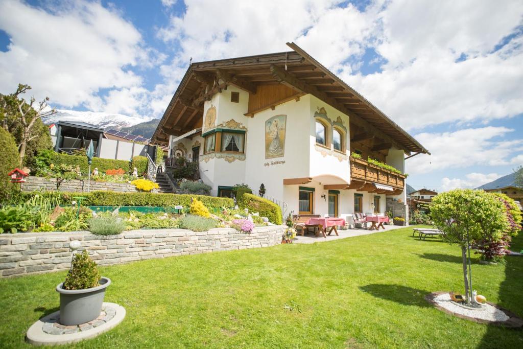 a house with a green yard with a house at Ferienwohnung Permoser in Neustift im Stubaital