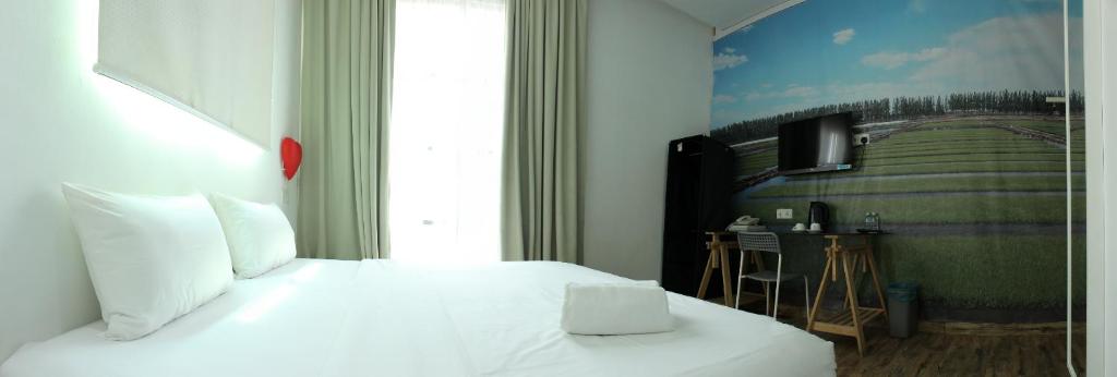 Postel nebo postele na pokoji v ubytování V Garden Hotel