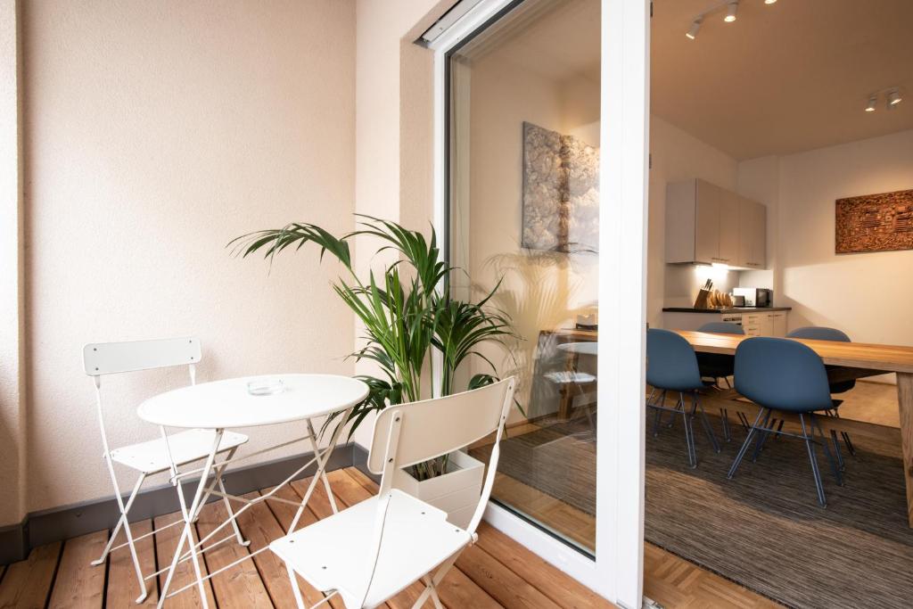 a dining room and living room with a table and chairs at City-Apartment Neubaugasse - PRIVATE PARKING GARAGE in Graz