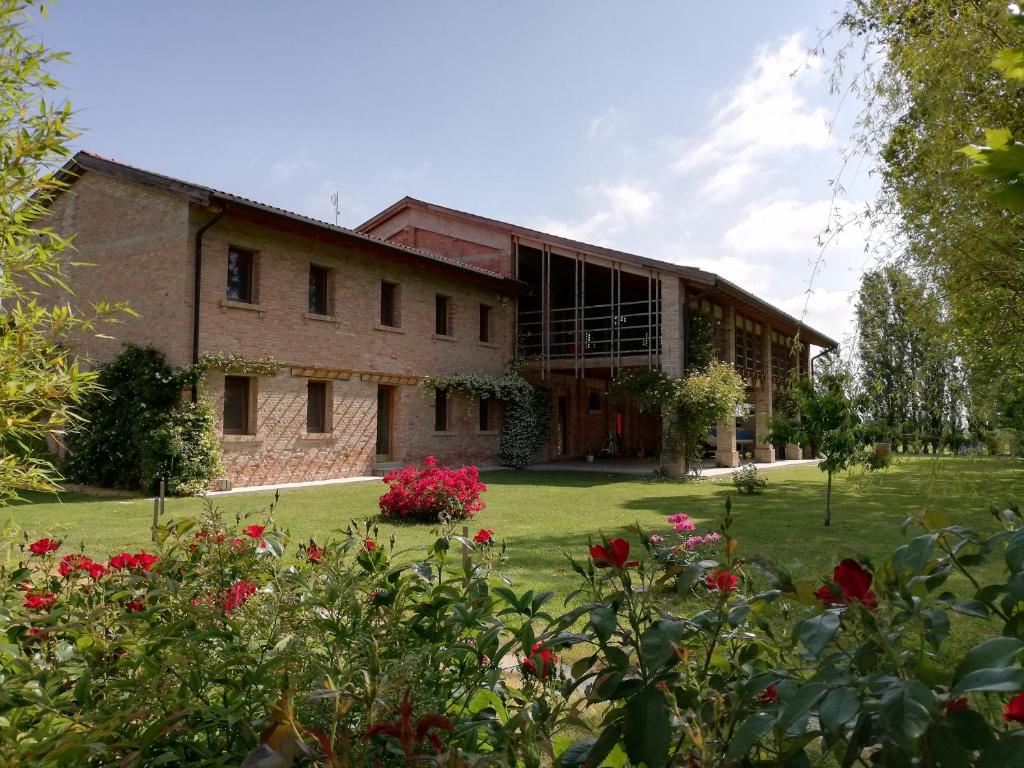 a large brick building with flowers in front of it at Ca' Adami in Brussa