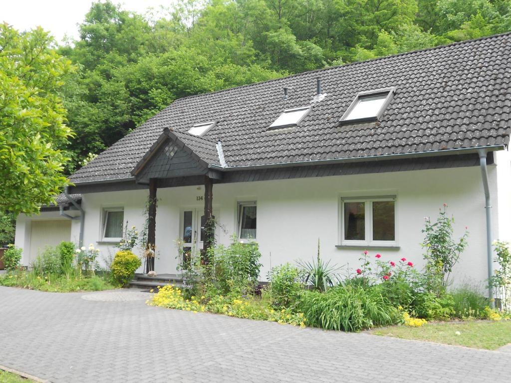 a white house with a black roof at fewo amendert in Cochem