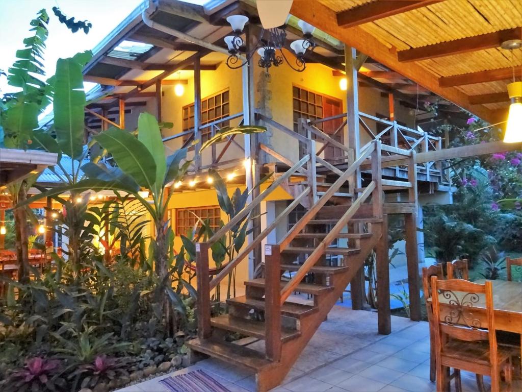 a staircase leading up to a patio area with tables and chairs at Hotel Pura Vida in Puerto Viejo