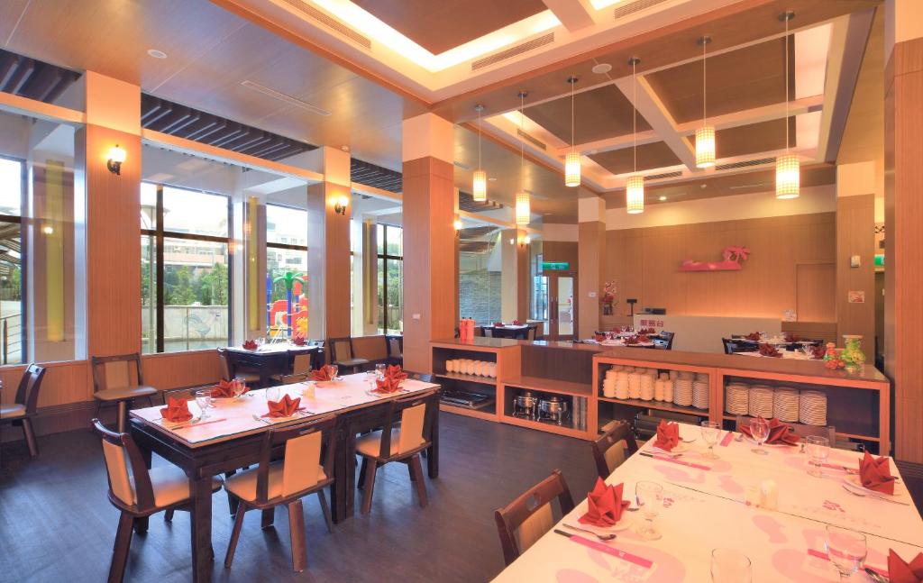 a dining room with tables and chairs in a restaurant at Jin Yong Quan Spa Hotspring Resort in Wanli District