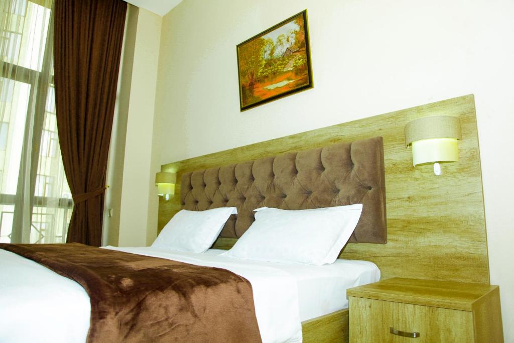 Postel nebo postele na pokoji v ubytování Hotel Grand