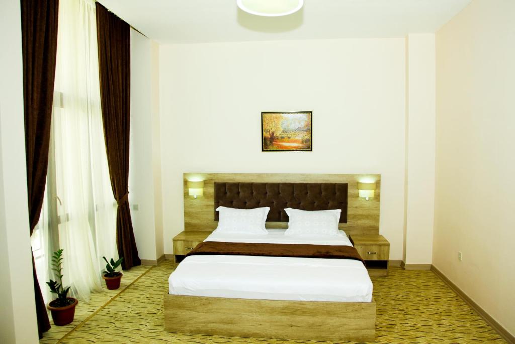 Postel nebo postele na pokoji v ubytování Hotel Grand