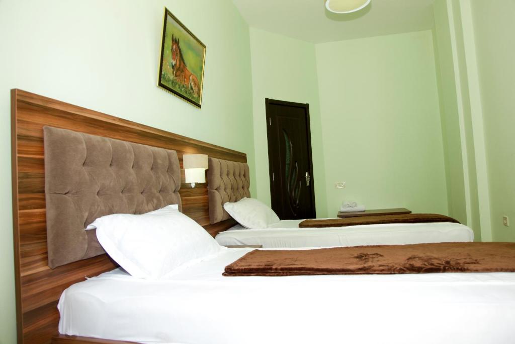 Postel nebo postele na pokoji v ubytování Hotel Grand