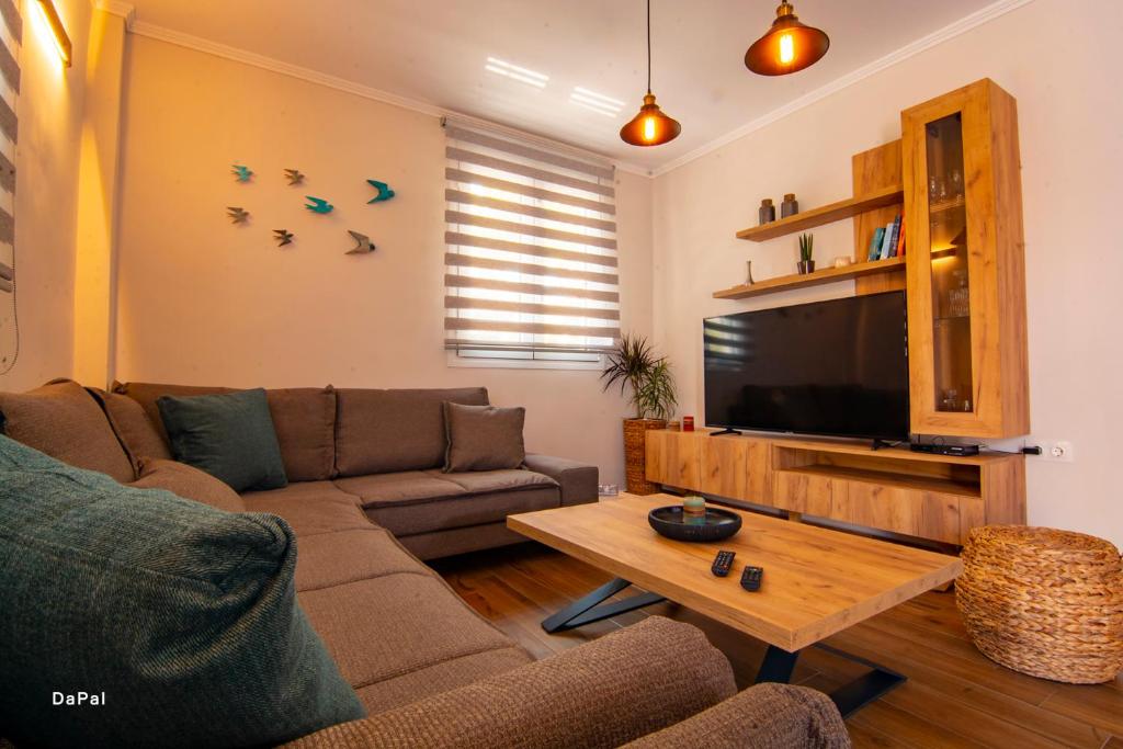 uma sala de estar com um sofá e uma televisão de ecrã plano em Bitsakis Family I - Paleochora Luxury House em Palaiochora