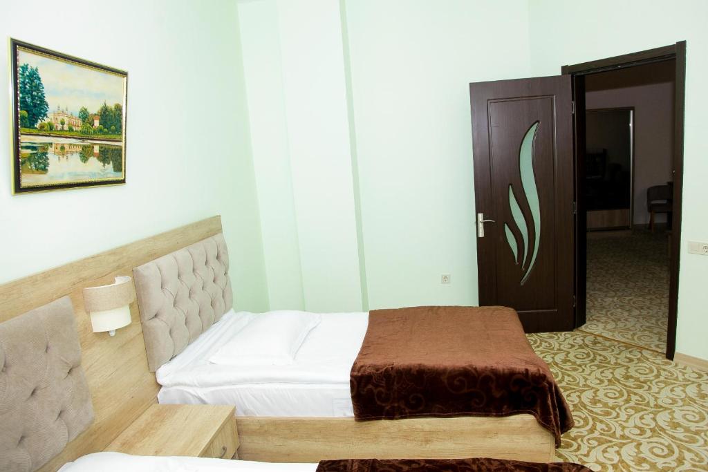 Postel nebo postele na pokoji v ubytování Hotel Grand
