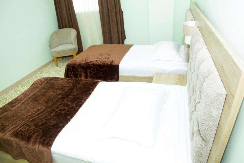 Postel nebo postele na pokoji v ubytování Hotel Grand
