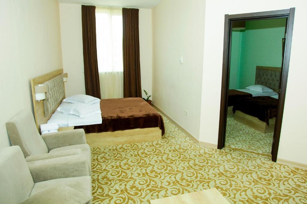 Postel nebo postele na pokoji v ubytování Hotel Grand