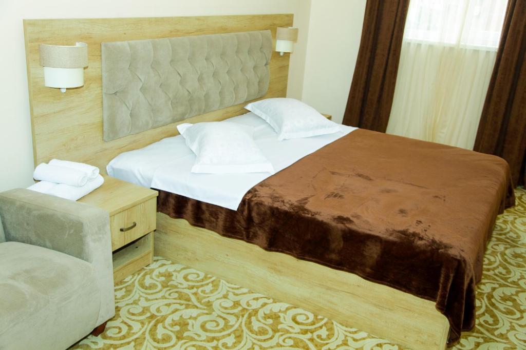 Postel nebo postele na pokoji v ubytování Hotel Grand