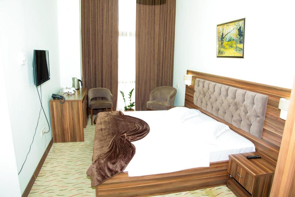 Postel nebo postele na pokoji v ubytování Hotel Grand