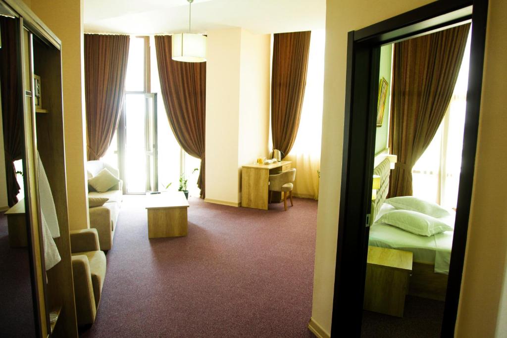 Postel nebo postele na pokoji v ubytování Hotel Grand
