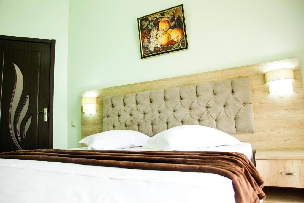 Postel nebo postele na pokoji v ubytování Hotel Grand