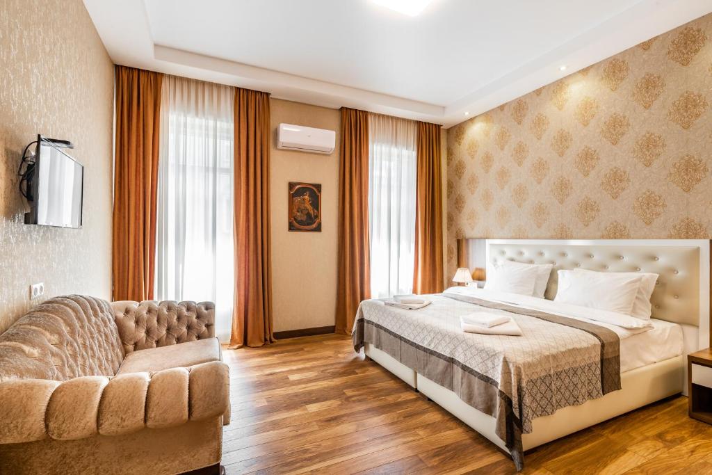 Postel nebo postele na pokoji v ubytování Ornament Hotel