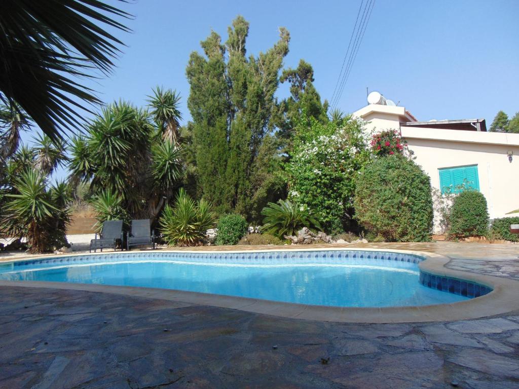 a swimming pool in front of a house at Konnos Villa in Protaras