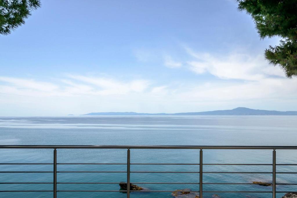 a view of the water from a balcony at Naftilos Blue View retreat in Avia