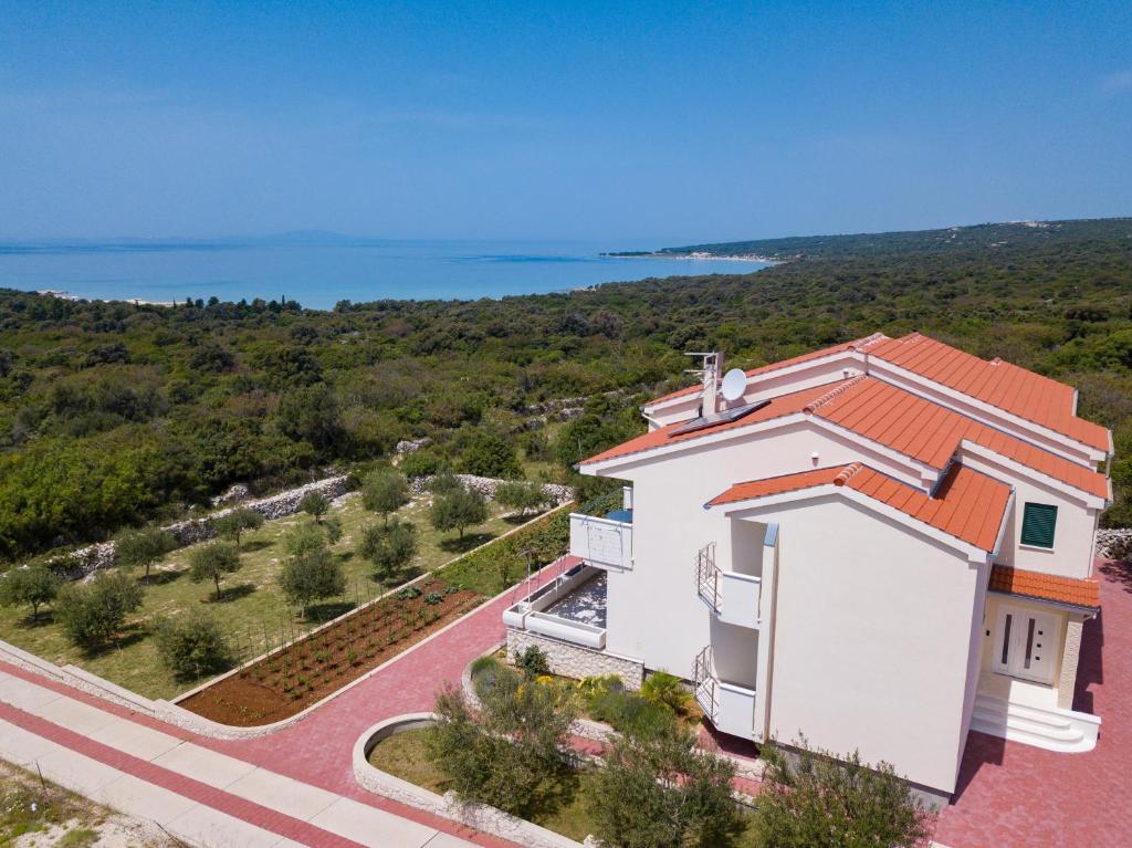 an aerial view of a white house with an orange roof at Agata Apartments in Novalja