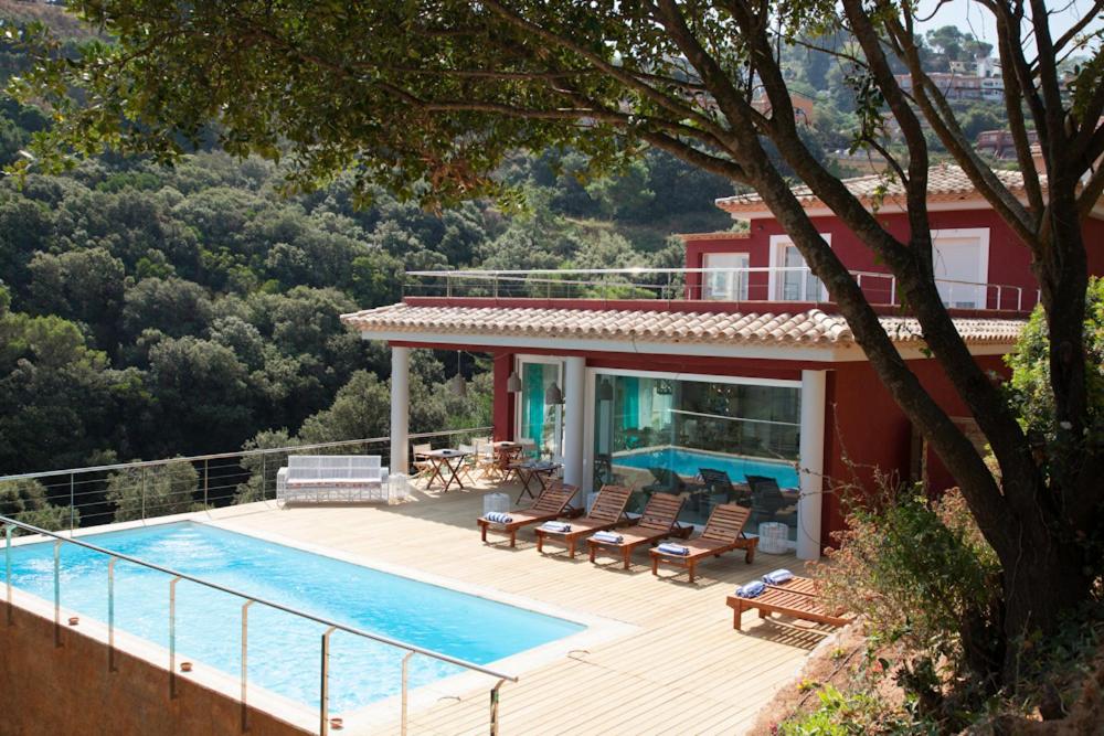 a villa with a swimming pool and a house at Es Cel de Begur Hotel in Begur