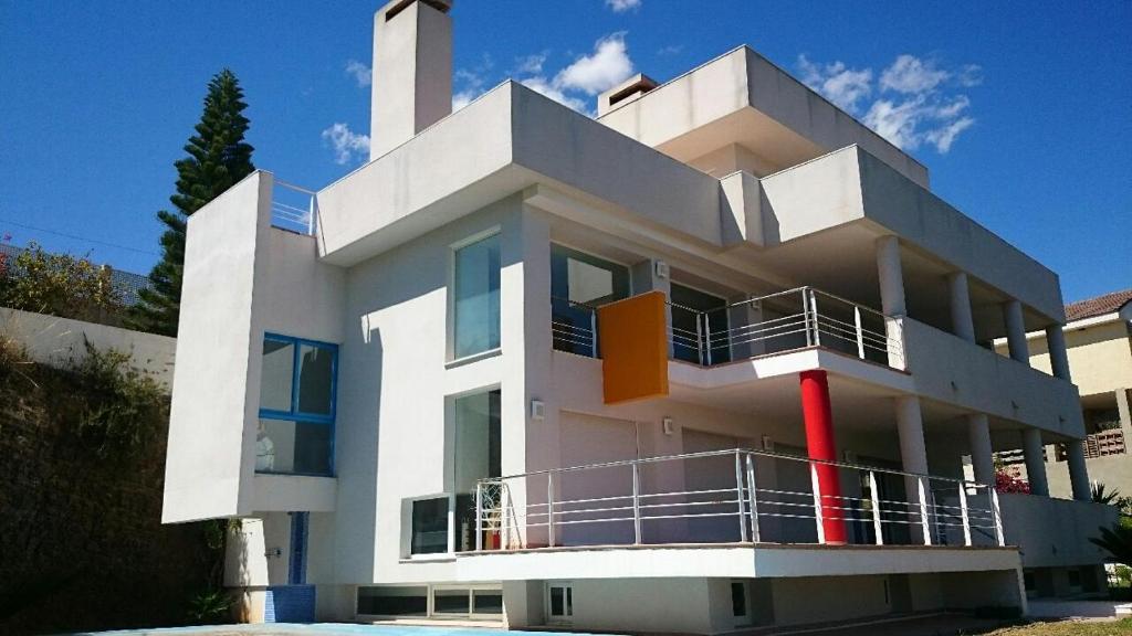 a large white building with a balcony in front of it at Chalet en Sierra Calderona in Valencia