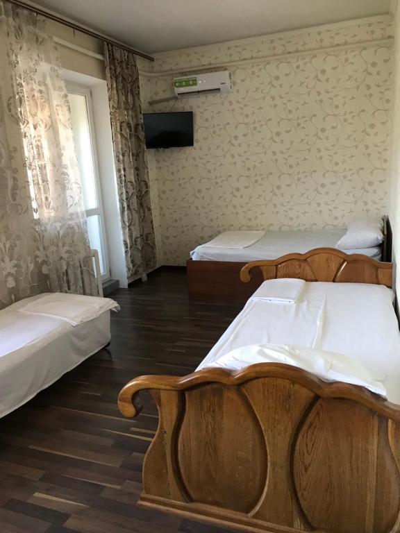 Postel nebo postele na pokoji v ubytování Гостевой дом Дина