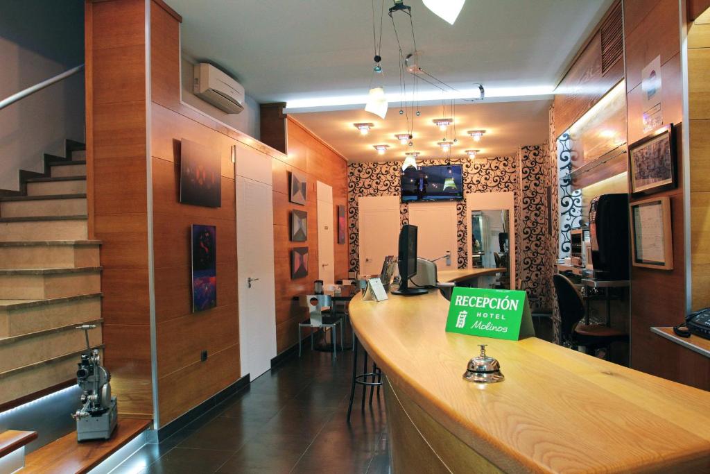 a bar with a sign on it in a room at Hotel Molinos in Granada