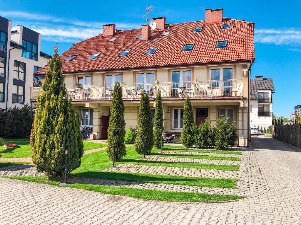 a large house with a red roof at Willa Milano in Mielno